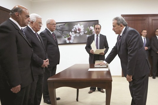 Mohamed Qassem, President of the Palestinian constitutional court, is sworn in by President Mahmoud Abbas (second left) in Ramallah on April 5.