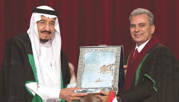 Custodian of the Two Holy Mosques King Salman of Saudi Arabia receiving a honorary doctorate degree from Jaber Nassar, the head of Cairou203as University,.