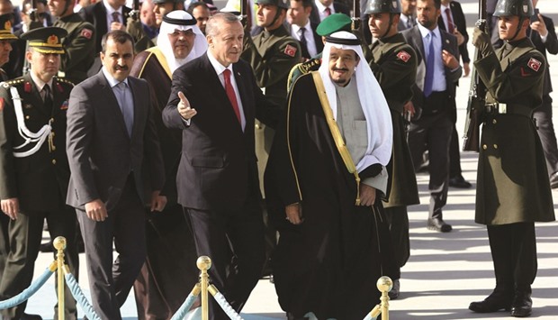 Turkish President Recep Tayyip Erdogan welcomes Custodian of the Two Holy Mosques King Salman of Saudi Arabia upon his arrival at Esenboga Airport in Ankara yesterday.