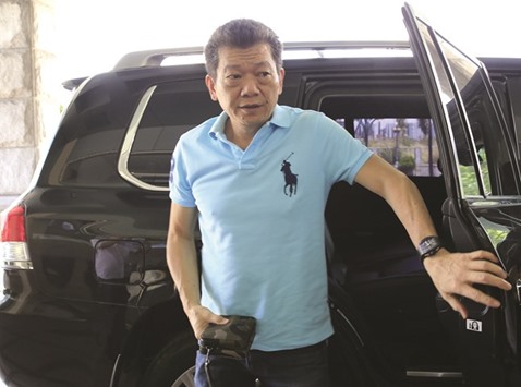 Chinese casino junket operator Kim Wong gets out of a vehicle upon arrival for a Reuters interview in Manila yesterday.