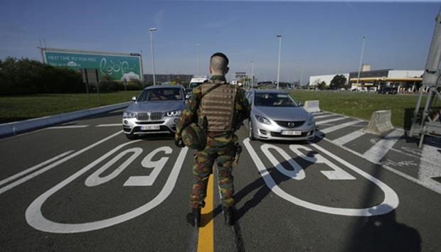 A soldier controls motorists arriving at Brussels' airport in Zaventem