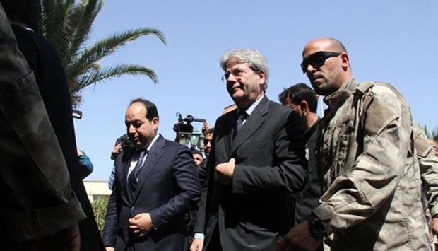 Italy's Foreign Minister Paolo Gentiloni (centre) walks alongside Libyan deputy prime minister of the UN-backed government, Ahmed Maiteeq (left), upon his arrival in Tripoli on Tuesday.
