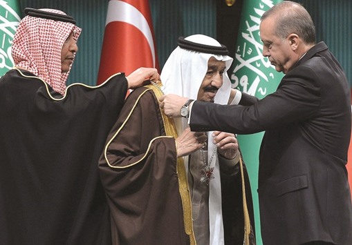 Turkish President Recep Tayyip Erdogan presents Turkeyu2019s highest state medal to Custodian of the Two Holy Mosques King Salman of Saudi Arabia during a ceremony at the presidential complex in Ankara yesterday.