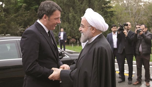Iranu2019s President Hassan Rouhani shakes hands with Italian Prime Minister Matteo Renzi during an official welcoming ceremony in Tehran yesterday.