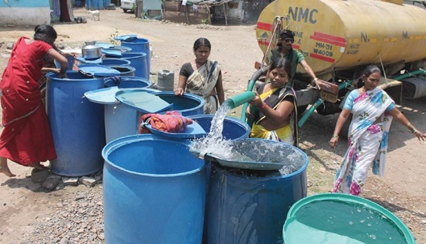 A woman fills containers from a water tanker in Nagpur yesterday. Nagpur and many other parts of Maharashtra are facing an acute shortage of water.