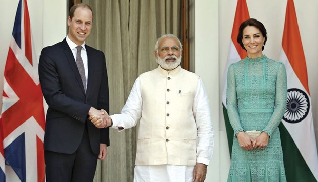 Prince William shakes hands with Prime Minister Narendra Modi as Duchess of Cambridge smiles during a photo opportunity at Hyderabad House in New Delhi yesterday.
