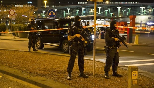 Dutch policemen stand guard outside Amsterdam's Schiphol Airport late on Tuesday after it was partially evacuated following a security alert.