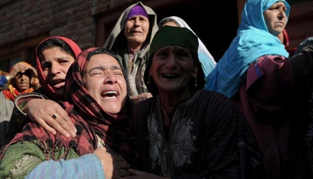 Kashmiri relatives of Raja Bejum, 70, who was killed in clashes with security forces, mourn during a funeral procession in Langate near Handwara on Wednesday.