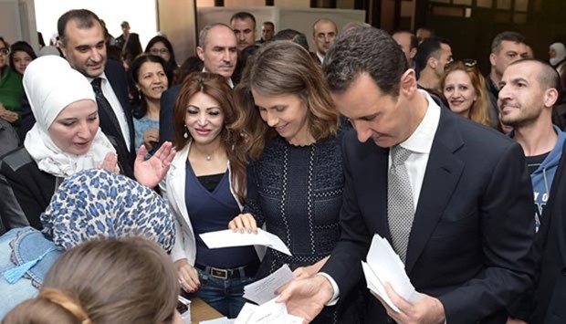 Syrian President Bashar al-Assad and his wife Asma prepare to cast their votes at a polling station in Damascus.