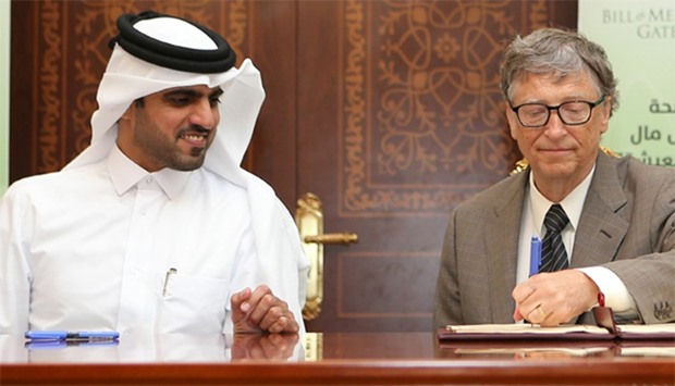 Bill Gates (R) and Khalifa bin Jassim al-Kuwari, the Director General of the Qatar Development Fund