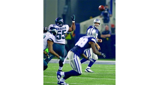 In this November 27, 2014, picture, Dallas Cowboys quarterback Tony Romo (right) hits wide receiver Dez Bryant (second from right) with a third quarter pass during their NFL game against Philadelphia Eagles in Arlington, Texas. (Fort Worth-Star Telegram/TNS)