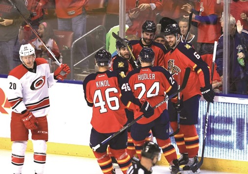 Florida Panthers players celebrate a goal as Carolina Hurricanes center Riley Nash (left) skates by during their NHL game earlier this month. Panthers won the game 5-2. (USA TODAY Sports)
