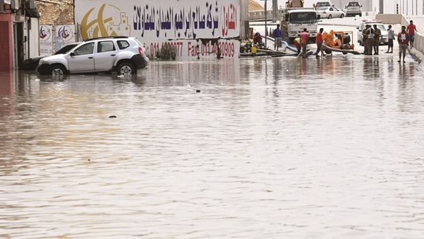 Riyadhu2019s municipal workers pump water from a flooded street in Riyadh during heavy rainfall across the Saudi capital yesterday.