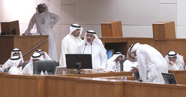 Kuwaiti Electricity and Water Minister Ahmad al-Jassar speaks as Oil and Finance Minister Anas al-Saleh (centre-back) looks on during a parliament session at the national assembly in Kuwait City yesterday. The parliament discussed a government proposal to increase electricity and water fees.