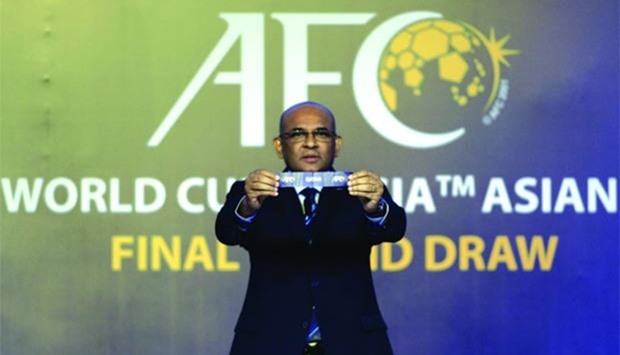 Windsor John, Asian Football Confederation (AFC) General Secretary, displays Qataru2019s name during the official draw for the final round of the 2018 World Cup football Asian qualifiers in Kuala Lumpur yesterday.