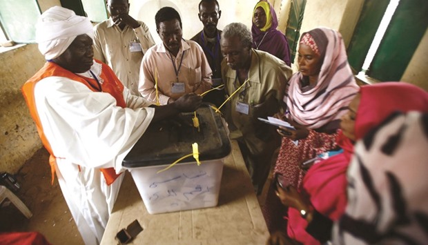 Sudanese election staff seal a ballot box at a polling station in North Darfuru2019s state capital El Fasher as the polls closed across Darfur yesterday in a referendum on the regionu2019s status with officials hailing the vote as a success.