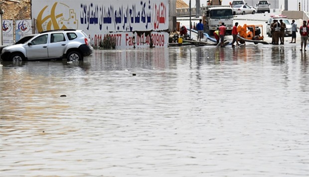 Riyadh's municipal workers pump water from a flooded street in Riyadh