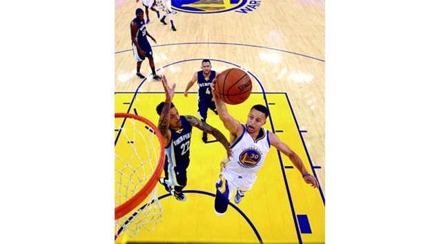 Golden State Warriors guard Stephen Curry (R) drives in for layup against Memphis Grizzlies forward Matt Barnes during second quarter at Oracle Arena. PICTURE: USA TODAY Sports