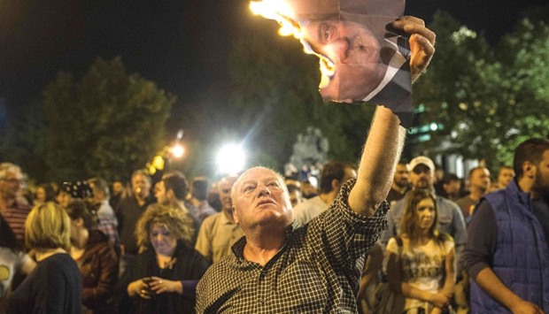 A protester burns a photo of Macedoniau2019s president in Skopje late on Wednesday.