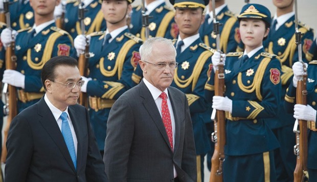 Australian Prime Minister Malcolm Turnbull reviews a military honour guard with Chinese Premier Li Keqiang during a welcoming ceremony in Beijing.