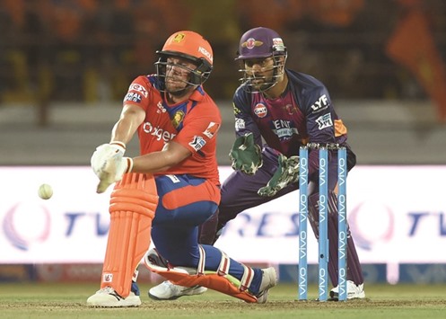 Gujarat Lions  Aaron Finch plays a shot as Rising Pune Supergiants captain Mahendra Singh Dhoni looks on during  IPL match in Rajkot yesterday. (AFP)