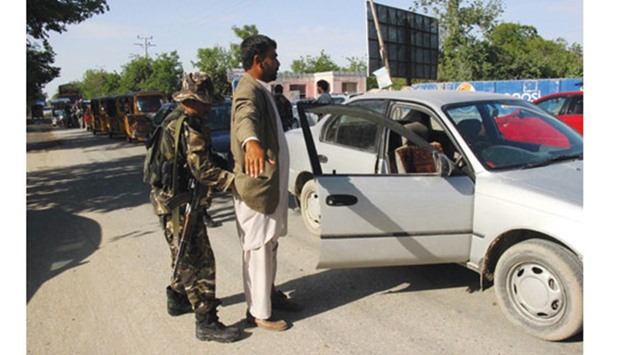 Security personnel searching commuters at a checkpoint in Kunduz province yesterday.
