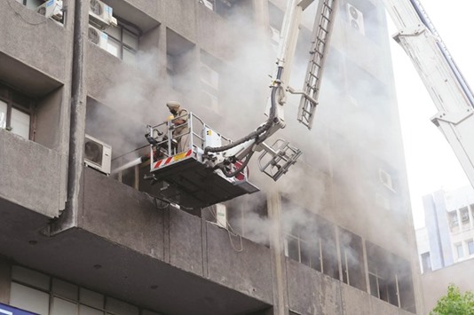 Firefighters try to douse a fire that broke out at Mercantile House in New Delhi yesterday.