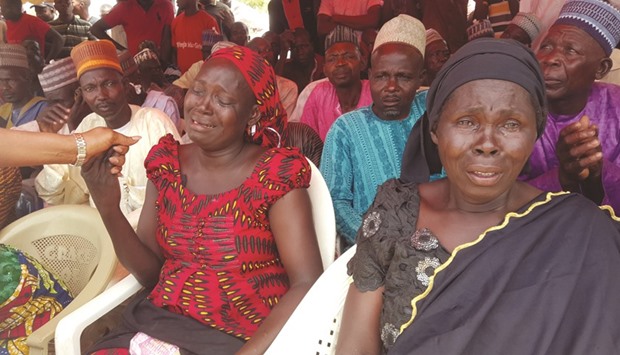 Parents of missing schoolgirls weeping during a vigil at the school site in Chibok. Boko Haram abducted a total of 276 girls from the Government Girls Secondary School in Chibok, northeast Nigeria, on April 14, 2014. Fifty-seven escaped in the immediate aftermath.  Search continues for the  219 girls still missing.
