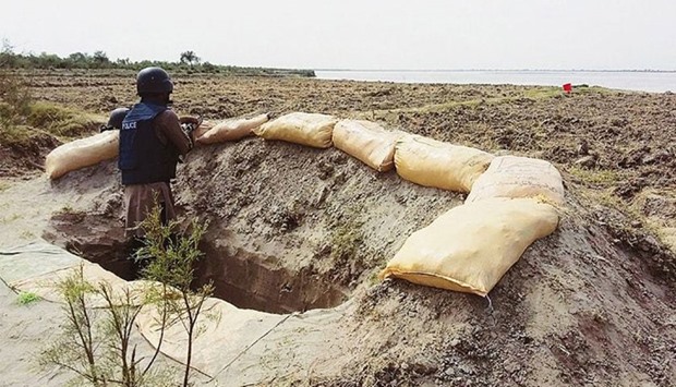 A policeman stands in a bunker during the operation against the criminal gang. Picture courtesy: Dawn, Pakistan