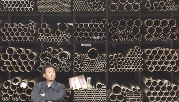 A vendor waits for customers at a steel pipe shop in Hefei, Anhui province. Chinau2019s steel output rose 2.9% in March from a year ago, beating market expectations, although total output in the first quarter was down 3.2% at 192.01mn tonnes, according to data from the National Bureau of Statistics.