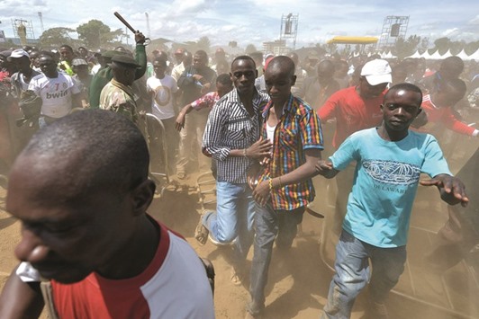 Supporters of Kenyau2019s President Uhuru Kenyatta and his deputy William Ruto overrun a security barricade to get closer to the podium during an inter-religious event at the Afraha stadium in Nakuru yesterday.