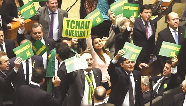 Deputies hold signs reading u201cImpeachment nowu201d and u201cBye darlingu201d during a session of the lower house of the Brazilian Congress in Brasilia yesterday.