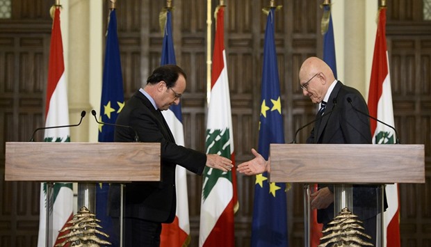 French President Francois Hollande (left) and Lebanese Prime Minister Tamam Salam shake hands during a press conference after their meeting in Beirut yesterday.