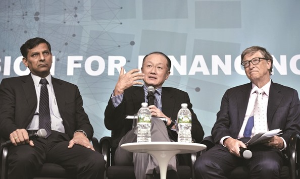 World Bank President Jim Yong Kim (centre), flanked by Reserve Bank of India Governor Raghuram Rajan (left) and Microsoft co-founder Bill Gates, speaks at a forum on financial development during the annual International Monetary Fund, World Bank Spring Meetings in Washington, DC. The IMFu2019s steering committee on Saturday urged member countries to boost u2018growth-friendlyu2019 spending and said the Fund should explore new lending tools to help deal with slowing global growth.