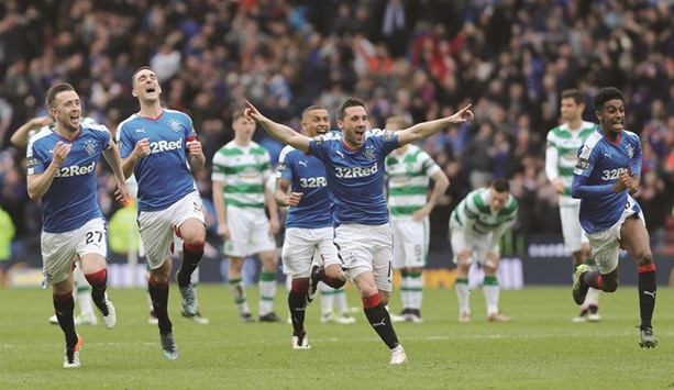 Rangers players celebrate their penalty shootout victory over Celtic. (Reuters)