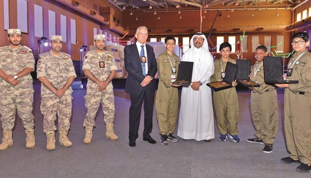 HE Dr Mohamed bin Saleh al-Sada with students and officials.