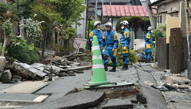 Policemen search for missing people in a damaged neighbourhood following two earthquakes in the region in Mashiki, Kumamoto prefecture. AFP