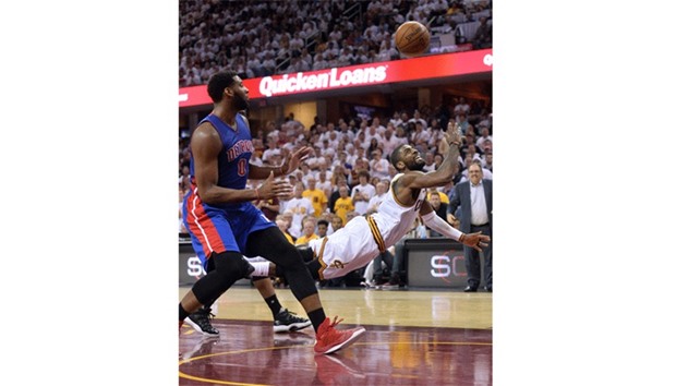 Cleveland Cavaliers guard Kyrie Irving (right) makes a lunging shot as Detroit Pistons center Andre Drummond (0) looks on during the game one of the NBA Playoffs. (USA TODAY Sports)