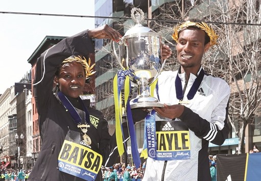 Womenu2019s and menu2019s winners Atsede Baysa and Lemi Berhanu Hayle of Ethiopia pose at the finish line after winning the 120th Boston Marathon in Boston, Massachusetts, yesterday. (AFP)