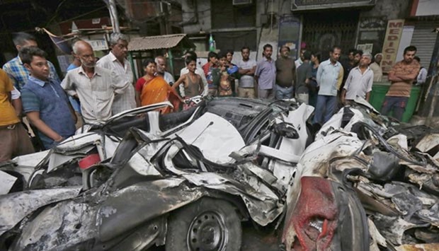 People look at wreckage caused when an under-construction flyover collapsed in Kolkata, on Friday.