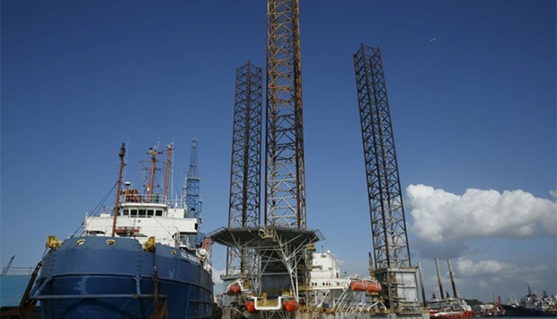 An oil-rig is pictured amongst vessels moored along a row of shipyards northwest of Waterfront City on Batam island, in Indonesia's Riau Islands Province
