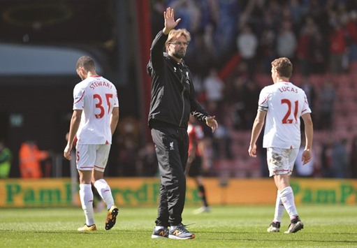 Liverpoolu2019s manager Jurgen Klopp (C) waves to the fans following the EPL match against Bournemouth at the Vitality Stadium in Bournemouth on April 17. Liverpool won the match 2-1. (AFP)