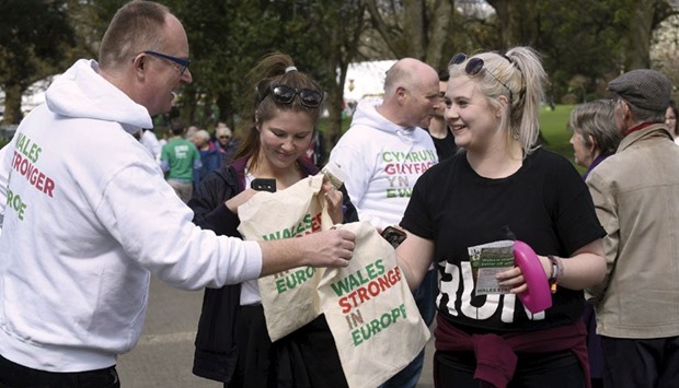 Wales Stronger in Europe supporters give out free shopping bags and leaflets in Bute Park, Cardiff, South Wales, Britain.