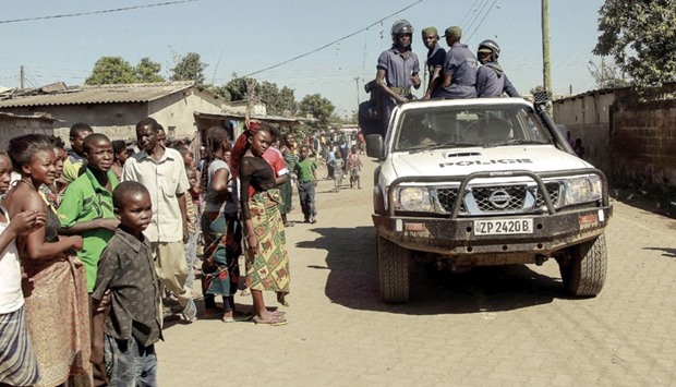Zambian police patrol near the Chawama compound where residents attacked and looted foreign-run shops in Lusaka.