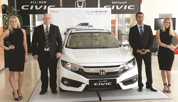 The 2016 Honda Civic is presented by Domascou2019s Faisal Sharif and Greig Roffey during the launch yesterday. PICTURE: Thajudeen