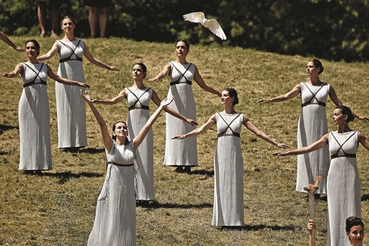An actress playing a priestess releases a dove at the ancient stadium of Olympia yesterday during a dress rehearsal for the lighting ceremony of the Olympic flame in ancient Olympia, the sanctuary where the Olympic Games were born in 776 BC.  (AFP)