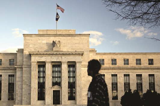 A pedestrian walks past the Federal Reserve building in Washington, DC. The Fed, Federal Deposit Insurance Corp and Office of the Comptroller of the Currency, which share  responsibility for supervising US banks, have told the lenders to present specific plans for their businesses in the event of a u2018Brexitu2019, according to sources.