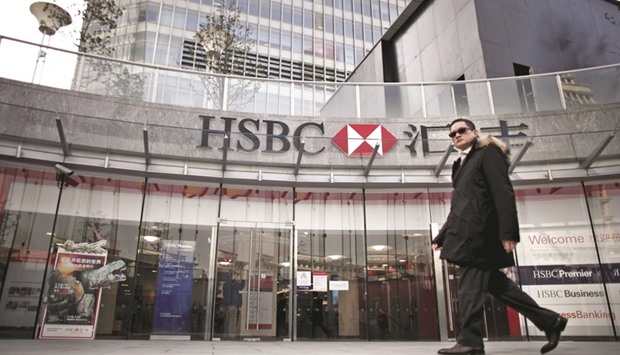 A man walks past the HSBC headquarters building in Pudong financial district in Shanghai. The bank, which has 65 outlets in Guangdong province, is hoping to produce $1bn a year in pre-tax-profit from the area.