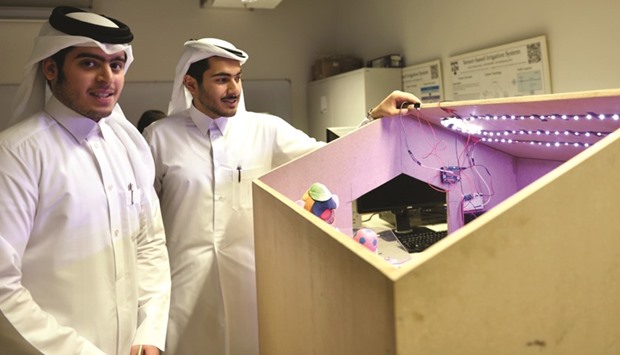 Two Qatari students of Tamuq with their project.