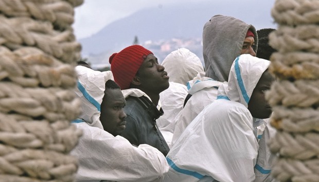 This file photo taken on February 1 shows men waiting to disembark from the Italian Coast Guard vessel u2018Dattilou2019 in the port of Messina, Sicily, following a rescue operation of migrants and refugees at sea. Migrants rescued from a small boat in the Mediterranean told the UN refugee agency that they had witnessed a shipwreck that claimed 500 lives, a UNHCR spokeswoman said yesterday.